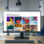 Computer monitor displaying a creative design website with vibrant nature and travel photography