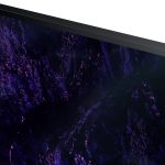 Close-up on a sleek, thin black monitor displaying vivid, abstract purple and blue graphics
