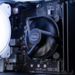 Close-up of a spinning CPU cooler fan on an Intel processor inside a computer