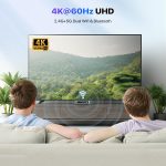 Two people watching a 4K UHD TV with 2.4G+5G dual WiFi and Bluetooth, displaying a scenic view