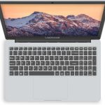 Sleek laptop with mountain wallpaper on screen, featuring full keyboard layout and trackpad. Perfect for students and professionals